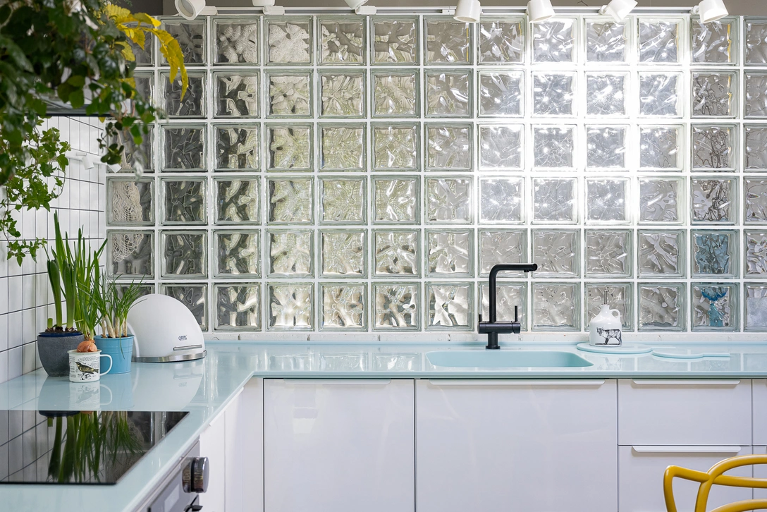 Мансарда в Санкт-Петербурге. Стенка из стеклоблоков отделяет кухню от прихожей и выполняет роль кухонного фартука. Кухонная мебель, ИКЕА. Столешница, Corian. Проект Гузели Елисеевой. | Источник: Наталия Горбунова