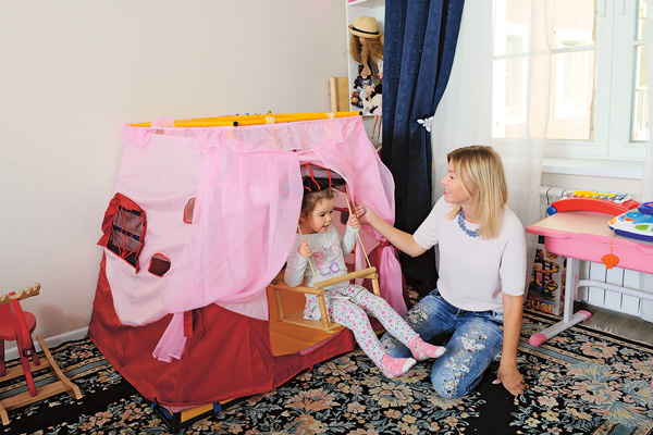 Домик с качелями – любимая игрушка Даши в ее детской комнате