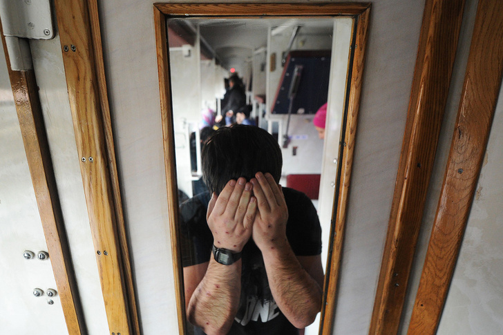 A picture taken in Terespol on December 21, 2016 shows a Chechen man showing scars on his forearms inside a train carriage while returning to the Belarusian city of Brest after a failed attempt to enter Poland. On a snowy day in late December, a commuter t